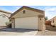 Neutral colored one story home featuring a two car garage with desert landscaping at 3323 W Fraktur Rd, Phoenix, AZ 85041