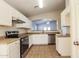 Bright kitchen with white cabinets, stainless steel appliances, and tile flooring at 3323 W Fraktur Rd, Phoenix, AZ 85041