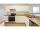 Efficient kitchen featuring white cabinetry, stainless steel appliances, and tile floors at 3323 W Fraktur Rd, Phoenix, AZ 85041