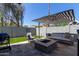 Landscaped backyard with artificial grass, fire pit, grill, and comfortable patio seating at 340 E Osborn Rd # 3, Phoenix, AZ 85012
