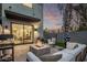 Evening view of a backyard with a fire pit, patio seating, and lush landscaping at 340 E Osborn Rd # 3, Phoenix, AZ 85012