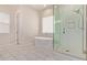 Bright bathroom with a sleek soaking tub and separate glass-enclosed shower at 340 E Osborn Rd # 3, Phoenix, AZ 85012