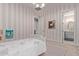 Charming bedroom with pink striped walls and ensuite bathroom at 340 E Osborn Rd # 3, Phoenix, AZ 85012