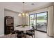 Dining room with a marble table, plush chairs, modern lighting, and sliding glass doors to outdoor living at 340 E Osborn Rd # 3, Phoenix, AZ 85012