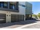 Stylish townhome with a glass-paneled garage door, modern facade, and well-kept parking area at 340 E Osborn Rd # 3, Phoenix, AZ 85012
