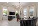 Bright living room featuring a modern chandelier, designer furniture, and views of the outdoors at 340 E Osborn Rd # 3, Phoenix, AZ 85012