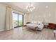 Elegant main bedroom with sliding glass doors to a private balcony, and a tufted headboard at 340 E Osborn Rd # 3, Phoenix, AZ 85012