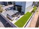 Private outdoor patio features turf lawn, a seating area with umbrella, and built-in grill at 340 E Osborn Rd # 3, Phoenix, AZ 85012