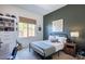 The bedroom boasts a striking accent wall, complemented by natural light from the window at 3429 E Constance Way, Phoenix, AZ 85042