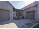 Three-car garage with brick paved driveway and desert landscaping at 3429 E Constance Way, Phoenix, AZ 85042