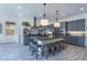 Well-lit kitchen with a large island, gray cabinets, and pendant lighting at 3429 E Constance Way, Phoenix, AZ 85042