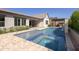 Beautiful backyard pool with tanning ledge, spa, waterfall feature, and outdoor seating area at 3429 E Constance Way, Phoenix, AZ 85042