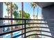 Enjoy this community view from the balcony with palm trees, a sparkling pool, and lush landscaping at 3633 N 3Rd Ave # 2012, Phoenix, AZ 85013