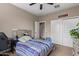 This bedroom features carpet flooring, ceiling fan, and a window for natural light at 3818 N 306Th Ave, Buckeye, AZ 85396
