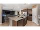 Open kitchen with island seating flows into the cozy living area, perfect for entertaining at 3818 N 306Th Ave, Buckeye, AZ 85396