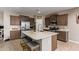 Modern kitchen featuring an island with seating, stainless steel appliances, and sleek, stylish cabinets at 3818 N 306Th Ave, Buckeye, AZ 85396