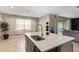 Bright and airy kitchen featuring an island with seating, stainless steel appliances, and tiled floors at 3818 N 306Th Ave, Buckeye, AZ 85396