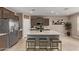 Modern kitchen featuring an island with seating, stainless steel appliances, and sleek, stylish cabinets at 3818 N 306Th Ave, Buckeye, AZ 85396