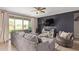 Comfortable living room with a stylish accent wall, plush seating, and sliding glass doors to the backyard at 3818 N 306Th Ave, Buckeye, AZ 85396