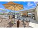 Outdoor patio area with desert landscaping, an umbrella for shade, and ample space for relaxation at 40511 N Birdie St, San Tan Valley, AZ 85140