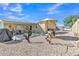 Spacious backyard with desert landscaping, a covered patio, and an inviting outdoor living space at 40511 N Birdie St, San Tan Valley, AZ 85140