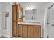 Well-lit bathroom with a vanity featuring plenty of storage cabinets and a full mirror at 40511 N Birdie St, San Tan Valley, AZ 85140
