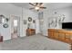 Bright and airy bedroom with wood furniture, plush carpet, and a view into the connecting bathroom at 40511 N Birdie St, San Tan Valley, AZ 85140