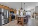 Modern kitchen with a central island, stainless steel appliances, and open layout to living area at 40511 N Birdie St, San Tan Valley, AZ 85140