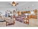 Spacious living room open to kitchen, featuring wood floors and comfortable seating at 40511 N Birdie St, San Tan Valley, AZ 85140