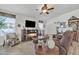 Comfortable living room with fireplace, ceiling fan, and rustic decor accents at 40511 N Birdie St, San Tan Valley, AZ 85140
