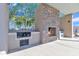 The built-in outdoor kitchen features a BBQ and stone fireplace, perfect for dining alfresco at 40511 N Birdie St, San Tan Valley, AZ 85140