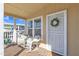 Cozy front porch with wicker seating and decorative wreath, perfect for relaxing outdoors at 40511 N Birdie St, San Tan Valley, AZ 85140