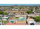 Aerial view of neighborhood featuring sparkling pools, lush green lawns, and mountain views at 4139 W Anderson Dr, Glendale, AZ 85308