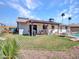 Beautiful backyard featuring a covered patio, game area, and manicured landscaping at 4139 W Anderson Dr, Glendale, AZ 85308