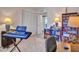 Bedroom with a dark blue keyboard, an office chair and a wooden bookshelf at 4139 W Anderson Dr, Glendale, AZ 85308