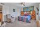 Bedroom with recliner, ceiling fan and built in headboard at 4139 W Anderson Dr, Glendale, AZ 85308