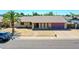 Charming single-story home with a brick facade, attached garage and well manicured lawn at 4139 W Anderson Dr, Glendale, AZ 85308