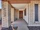 Charming front porch with brick columns, a decorative front door, and a welcoming entrance at 4139 W Anderson Dr, Glendale, AZ 85308