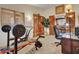 A view of a home gym including free weights, an exercise bike, carpet flooring, and decor at 4139 W Anderson Dr, Glendale, AZ 85308