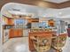 An open kitchen featuring an island with chairs, a tile backsplash, and stainless steel appliances at 4139 W Anderson Dr, Glendale, AZ 85308