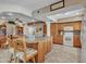 A view of the kitchen with wood cabinets, granite countertops and a breakfast bar with 2 chairs at 4139 W Anderson Dr, Glendale, AZ 85308