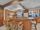 The open kitchen has an island with chairs, a tile backsplash, and stainless steel appliances at 4139 W Anderson Dr, Glendale, AZ 85308