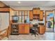 A kitchen desk with wood cabinets and a beverage fridge is right next to a sliding glass door at 4139 W Anderson Dr, Glendale, AZ 85308