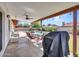 Covered patio with ceiling fan, outdoor seating, and grill overlooking the refreshing pool at 4139 W Anderson Dr, Glendale, AZ 85308