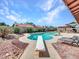 Backyard pool featuring a diving board, ample patio space, and lush greenery at 4139 W Anderson Dr, Glendale, AZ 85308