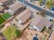 A picturesque aerial view of backyard spaces featuring green lawns and cozy patios, perfect for outdoor entertaining at 4213 E Shapinsay Dr, San Tan Valley, AZ 85140