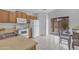 A bright kitchen is featured with an eat-in dining table near a sliding glass door to the backyard at 4213 E Shapinsay Dr, San Tan Valley, AZ 85140