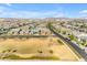 Expansive aerial view showcasing a Primary-planned community with manicured lawns, tree-lined streets, and mountain views at 4247 S Zenith --, Mesa, AZ 85212