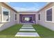 A long backyard features green grass and tile stepping stones to an outdoor living space at 4247 S Zenith --, Mesa, AZ 85212
