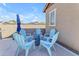 Backyard patio with blue chairs and an umbrella, perfect for outdoor entertaining and relaxation at 4247 S Zenith --, Mesa, AZ 85212